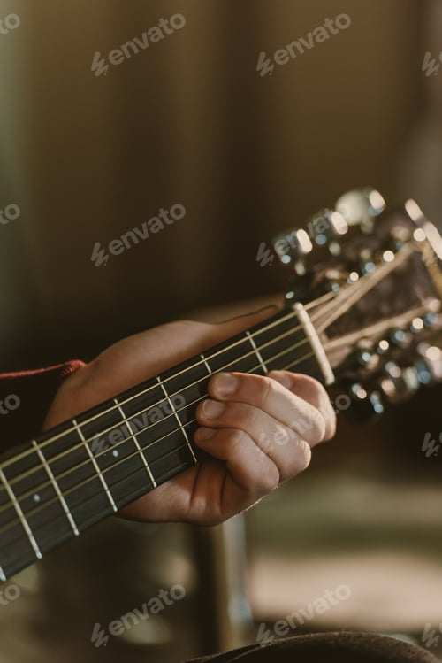 Preview: cropped shot of man playing acoustic guitar