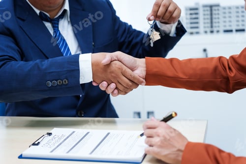 Preview: A businessman desk in a sales office sells a condo building customer.They agree to sign a contract