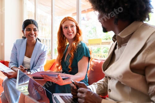 Preview: Multiethnic small group of businesspeople meeting in a coworking company office
