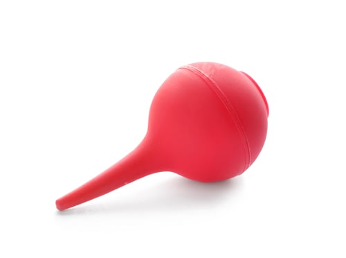 Preview: Red enema on white background. Medical treatment