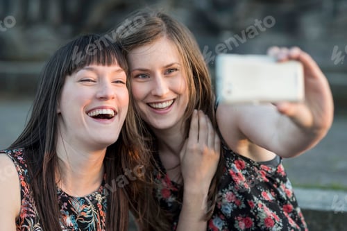 Preview: Two happy young women taking a selfie
