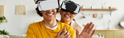 Preview: Joyful couple sharing a fun moment at home using virtual reality headsets