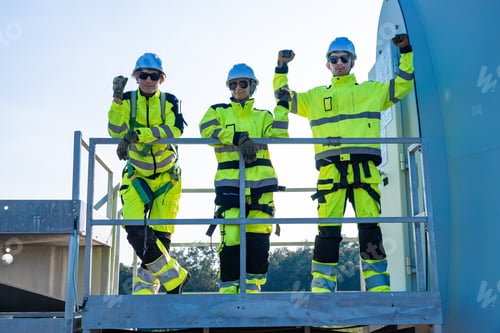 Preview: Confident engineers celebrating on platform