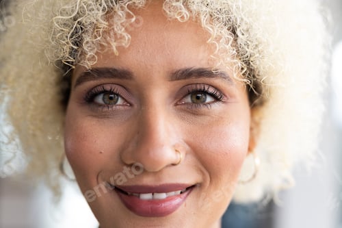 Preview: In modern office, biracial young female with curly blonde hair, smiling