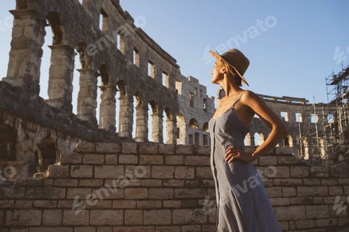 Preview: Beautiful tourist woman visiting the sights in Pula, Croatia. Vacation in Europe at summertime.