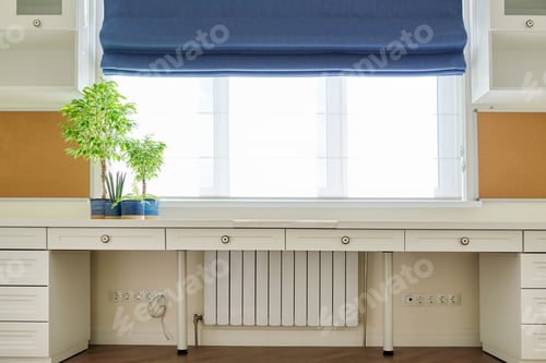 Preview: Interior of room, workplace near window, furniture, desk, blue roman blind, wall shelves