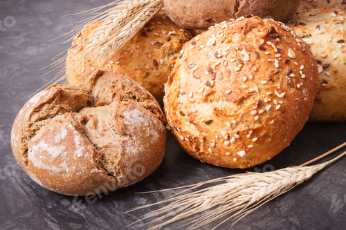 Preview: Fresh baked rolls with seeds and ears of rye or wheat grain