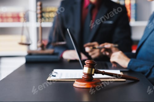 Preview: Lawyer working with client discussing contract papers with brass scale about legal legislation.