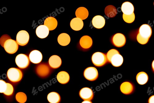 Preview: Unfocused abstract gold bokeh on black background. defocused and blurred many round light