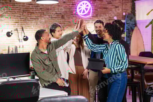 Preview: Startup team celebrating success, giving high five in modern office