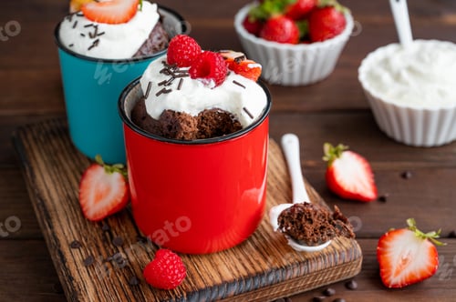Preview: Chocolate mug cake with whipped cream and fresh berries. Cupcake cooked in the microwave.