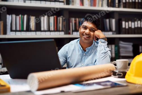 Preview: Portrait of a young architect working at his desk in a modern office