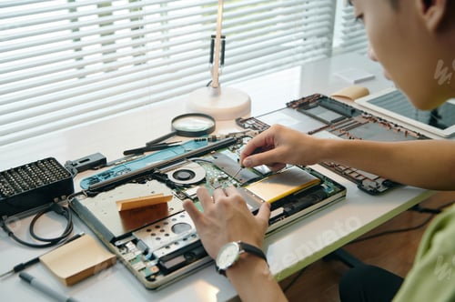 Preview: Repairman Repairing Laptop In Workshop