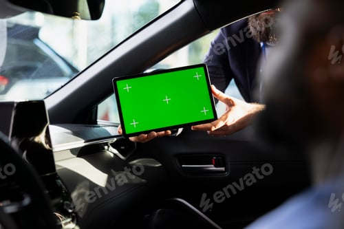 Preview: Showroom agent helps customer evaluate automobile, showing green screen device