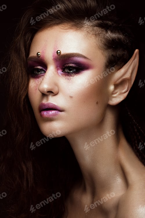 Preview: Brunette girl with a creative hairstyle braids, art make-up and the elf's ears. Beauty face.