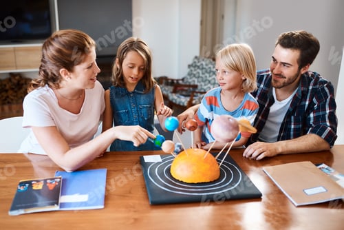 Preview: Shot of a beautiful young family working together on a science project at home