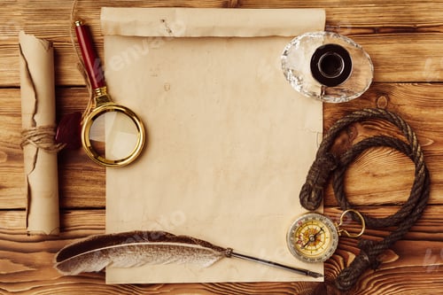 Preview: Old paper on brown wood background with feather
