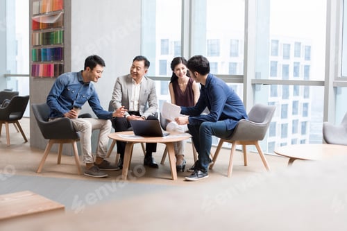 Preview: Chinese business people talking in meeting with a laptop