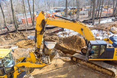 Preview: A large excavator is digging on an industrial site for development of infrastructure