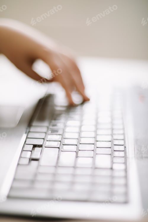 Preview: Close-up of male hands typing on laptop keyboard indoors. Businessman working in office or student