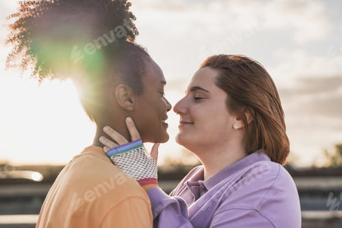 Preview: Happy lesbian couple having tender moment outdoor at sunset