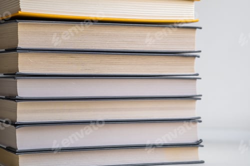 Preview: Stack of books on a white background. One book is yellow.