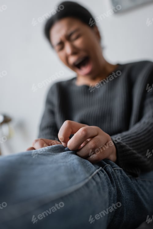 Preview: Blurred multiracial woman with mental problem crying at home