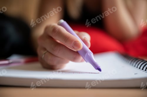 Preview: Low angle closeup view of a female student studying