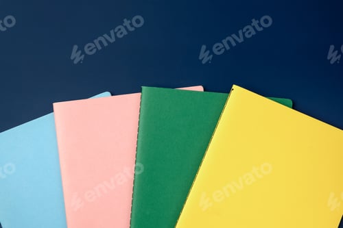 Preview: top view pastel notebook with pencil and stationery on navy blue table background