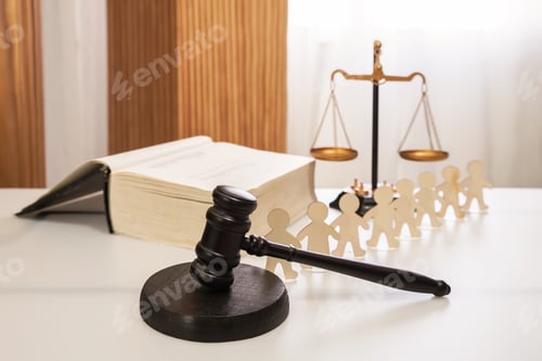 Preview: Judge's gavel against the background of a statute book and scales of justice