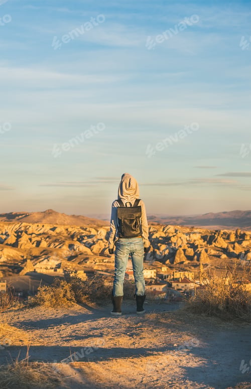 Preview: Young woman traveller standing and watching sunrise, Cappadocia, Central Turkey
