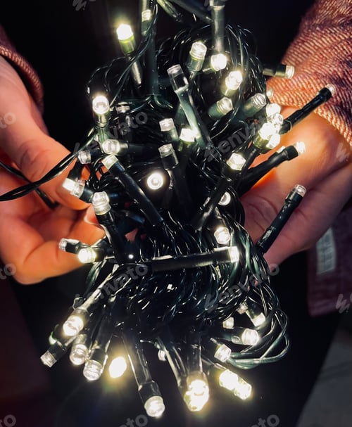 Preview: New Year's garland in the hands of a girl