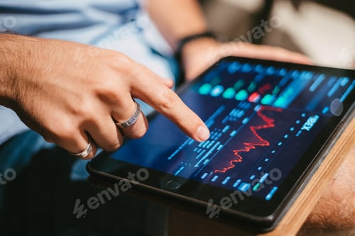Preview: Man checking stock market data on tablet