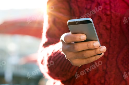Preview: Hand typing on phone