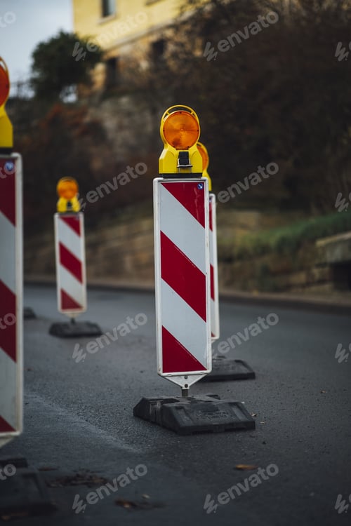 Preview: Vertical shot of street signs on the road with a blurred background