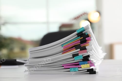 Preview: Stack of documents with paper clips on office table