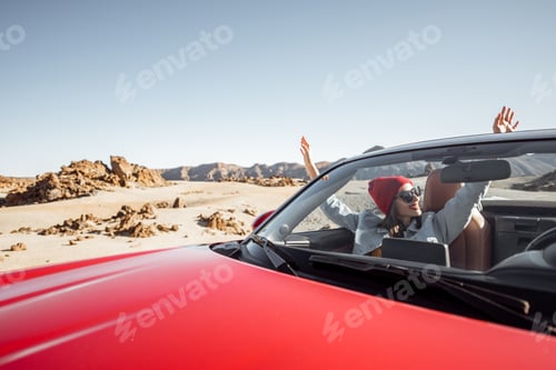 Preview: Woman traveling by cabriolet car on the desert velley