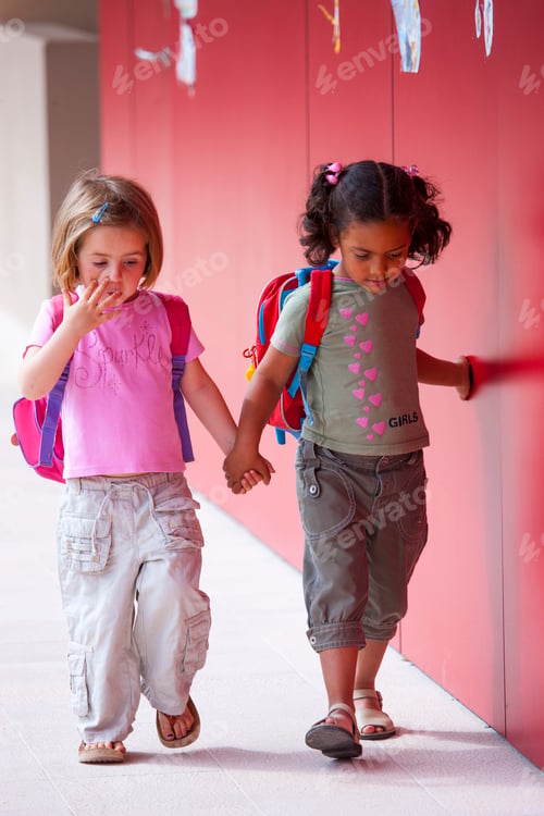 Preview: Two preschool girls holding hands and walking outside preschool