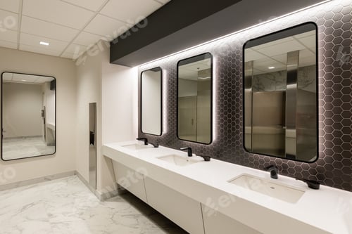 Preview: Modern bathroom with three white porcelain sinks lined up against a mirrored wall.