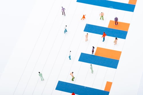 Preview: High angle view of people figures on surface with blue and orange diagram isolated on white,