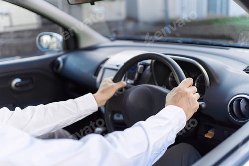 Preview: Hands of a man driving a car