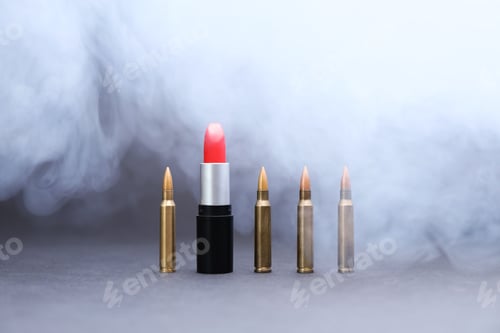 Preview: Red lipstick among bullets in smoke on grey background