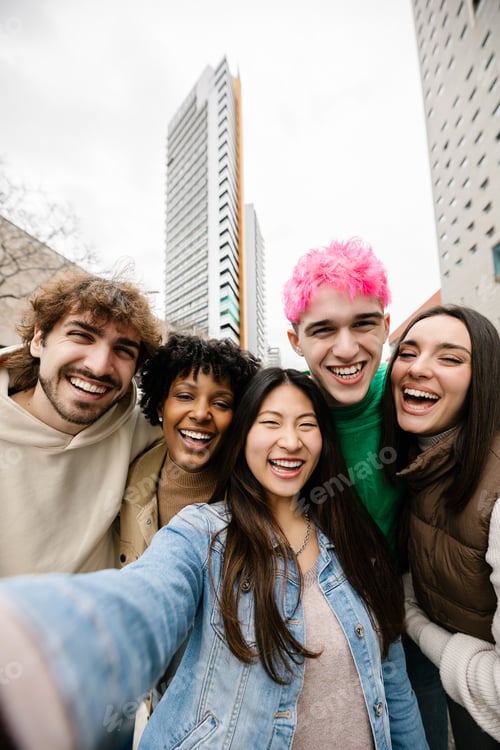 Preview: Diverse group of happy young friends having fun taking selfie photo together