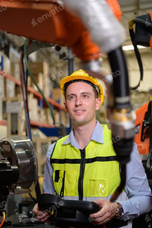 Preview: A male worker is controlling a welding robot.