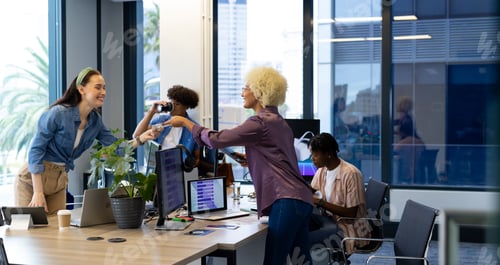 Preview: Diverse colleagues collaborating in modern office for a business start-up
