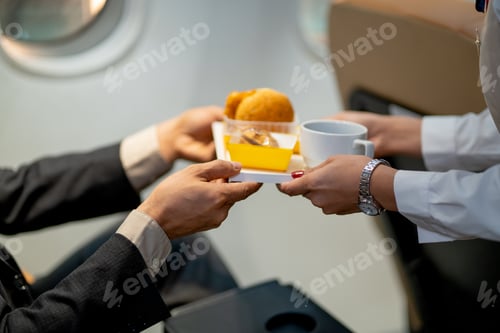Vista previa: Las manos de primer plano del pasajero reciben postre y pastel de la azafata o la tripulación de cabina