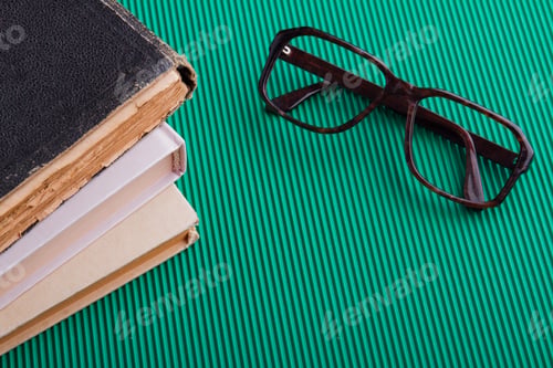 Preview: Close-up eyeglasses frame with book and copy space.