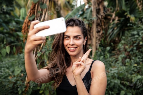Preview: A girl takes a selfie in the jungle.