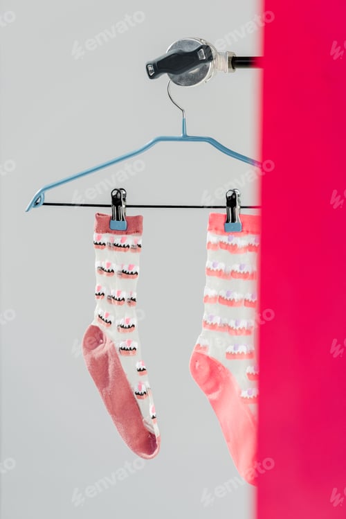 Preview: pair of pink socks with cake pattern on hanger