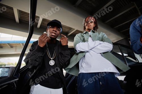 Preview: Young African American man in cap and black bomber jacket and his buddy